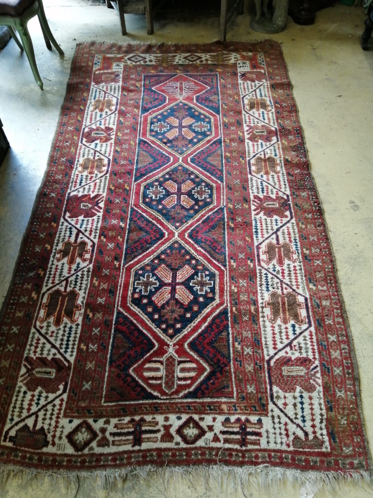A Causcasian polychrome geometric ground rug, 260 x 130cm